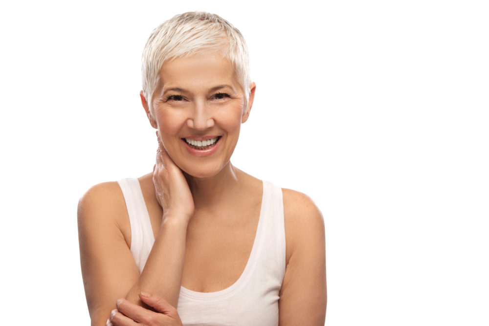 Portrait of a beautiful elderly woman, smiling, isolated on white background