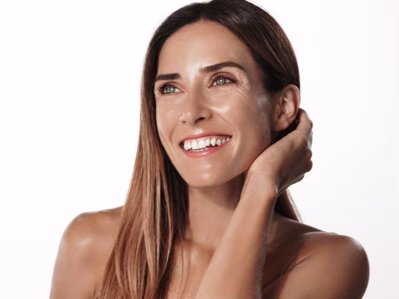 Smiling woman with radiant skin after a Vi Chemical Peel treatment, known for rejuvenating skin texture and addressing signs of aging.